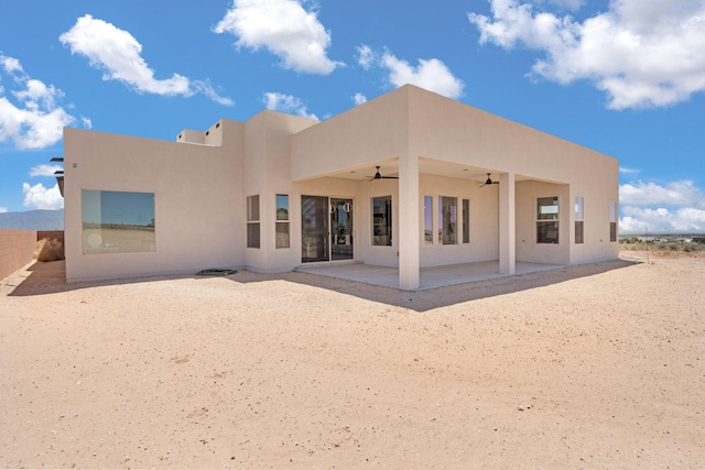1413 6th St SE, Rio Rancho, NM 87124 - back of house featuring ceiling fan, stucco siding, and a patio