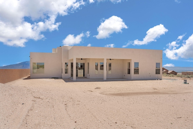 1413 6th St SE, Rio Rancho, NM 87124 - rear view of property featuring a ceiling fan, stucco siding, and a patio area
