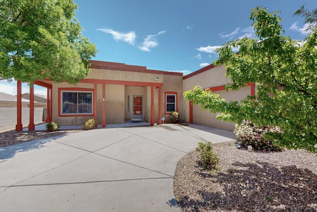 6500 Moon Shadows Dr NW, Albuquerque, NM 87120 - view of front of house with stucco siding, a garage, and concrete driveway
