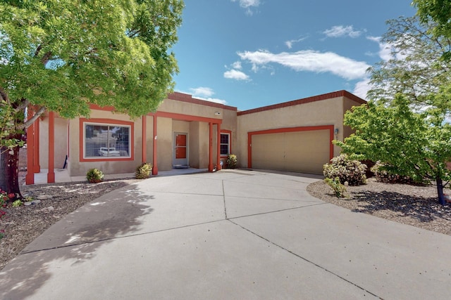 6500 Moon Shadows Dr NW, Albuquerque, NM 87120 - view of front of house with stucco siding, concrete driveway, and an attached garage