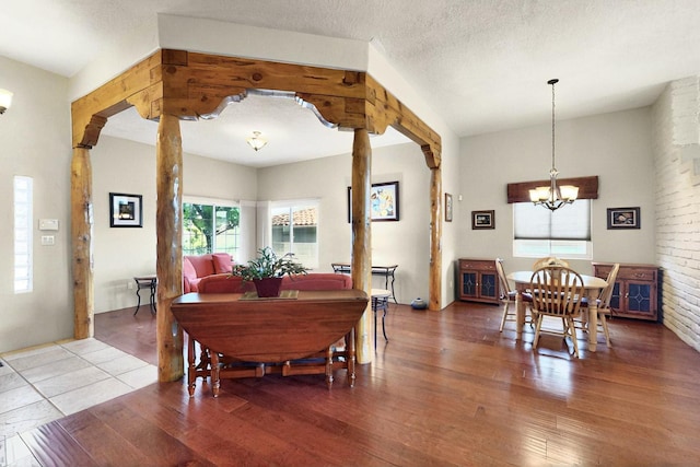 6500 Moon Shadows Dr NW, Albuquerque, NM 87120 - dining room featuring a chandelier, wood finished floors, and ornate columns