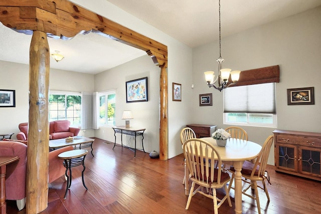 6500 Moon Shadows Dr NW, Albuquerque, NM 87120 - dining area featuring wood finished floors, a chandelier, and decorative columns