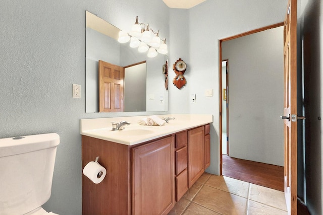 6500 Moon Shadows Dr NW, Albuquerque, NM 87120 - bathroom with toilet, vanity, and a textured wall