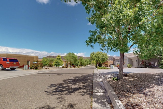 6500 Moon Shadows Dr NW, Albuquerque, NM 87120 - view of asphalt street with sidewalks and curbs