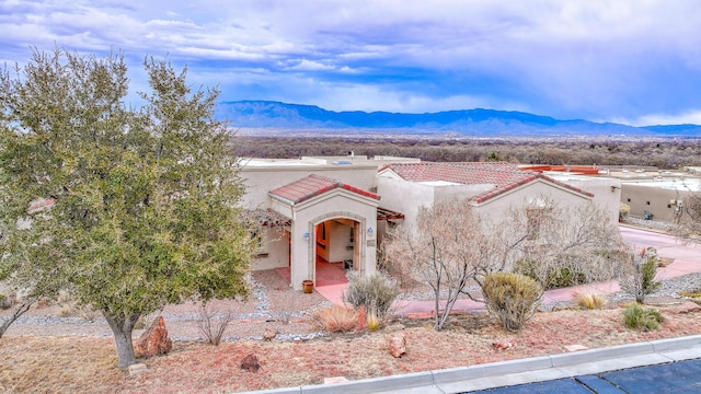 4110 Waterwillow Pl NW, Albuquerque, NM 87120 - view of front of house with stucco siding, a mountain view, and a tiled roof