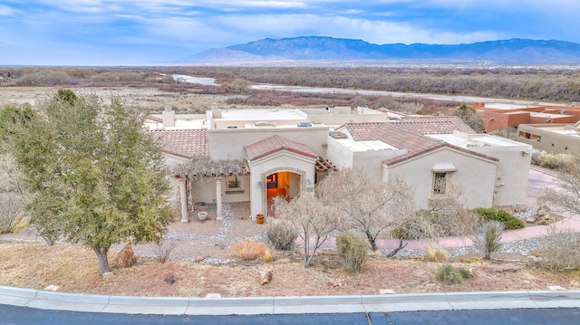 4110 Waterwillow Pl NW, Albuquerque, NM 87120 - mediterranean / spanish house featuring stucco siding, a mountain view, and a tile roof