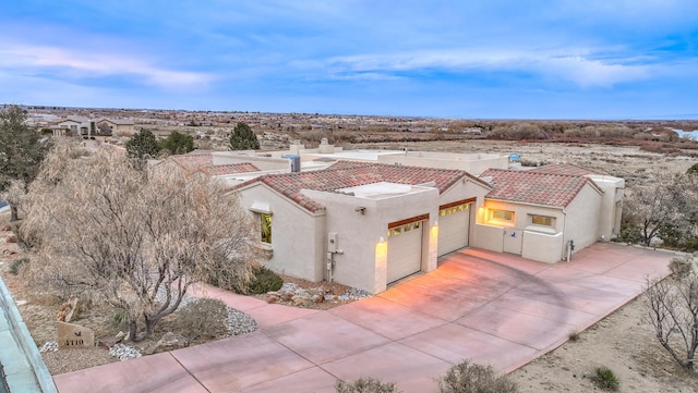 4110 Waterwillow Pl NW, Albuquerque, NM 87120 - view of front of home featuring a garage, stucco siding, a tiled roof, and concrete driveway
