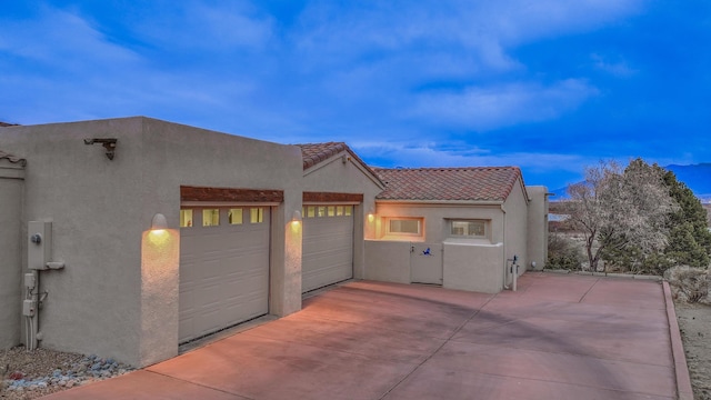 4110 Waterwillow Pl NW, Albuquerque, NM 87120 - view of property exterior featuring stucco siding, an attached garage, and a tile roof
