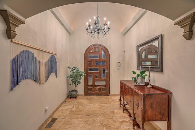 4110 Waterwillow Pl NW, Albuquerque, NM 87120 - foyer entrance featuring vaulted ceiling, a chandelier, arched walkways, and stone finish flooring