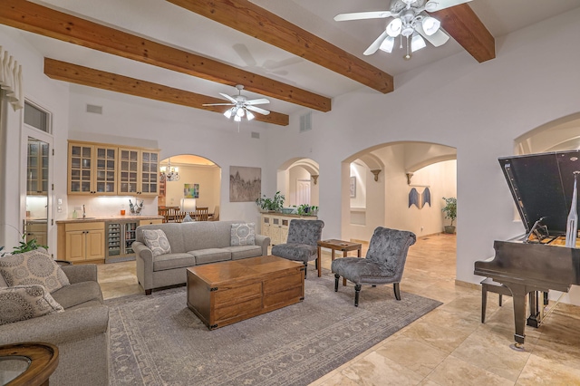 4110 Waterwillow Pl NW, Albuquerque, NM 87120 - living room featuring a ceiling fan, arched walkways, beamed ceiling, wet bar, and beverage cooler