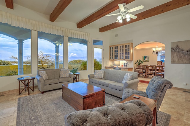 4110 Waterwillow Pl NW, Albuquerque, NM 87120 - living room with arched walkways, beam ceiling, a chandelier, a ceiling fan, and light stone finish flooring