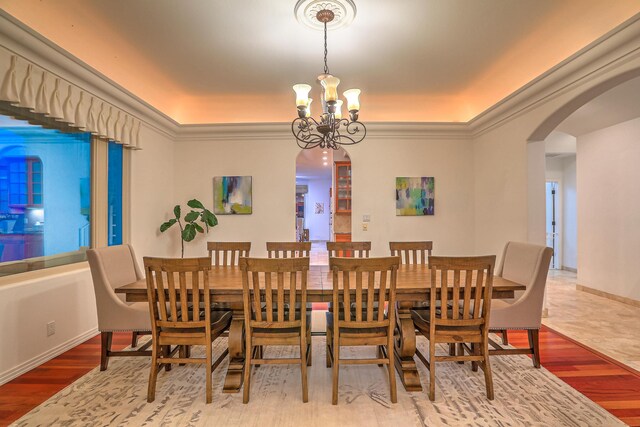 4110 Waterwillow Pl NW, Albuquerque, NM 87120 - dining area featuring a chandelier, arched walkways, wood finished floors, and ornamental molding