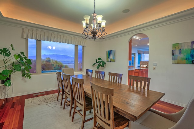 4110 Waterwillow Pl NW, Albuquerque, NM 87120 - dining area with arched walkways, a chandelier, and wood finished floors