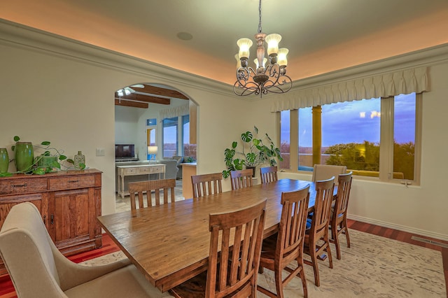 4110 Waterwillow Pl NW, Albuquerque, NM 87120 - dining space with arched walkways, a chandelier, and wood finished floors