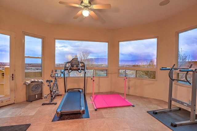 4110 Waterwillow Pl NW, Albuquerque, NM 87120 - exercise room featuring a ceiling fan, a mountain view, healthy amount of natural light, and tile patterned floors