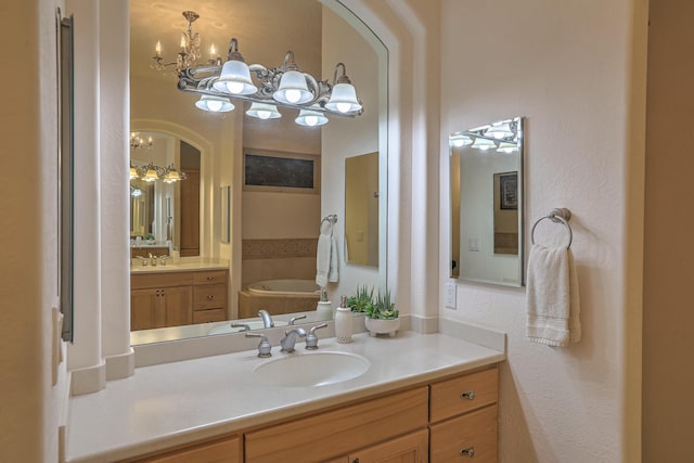4110 Waterwillow Pl NW, Albuquerque, NM 87120 - full bath featuring a chandelier, vanity, a bath, and a textured wall