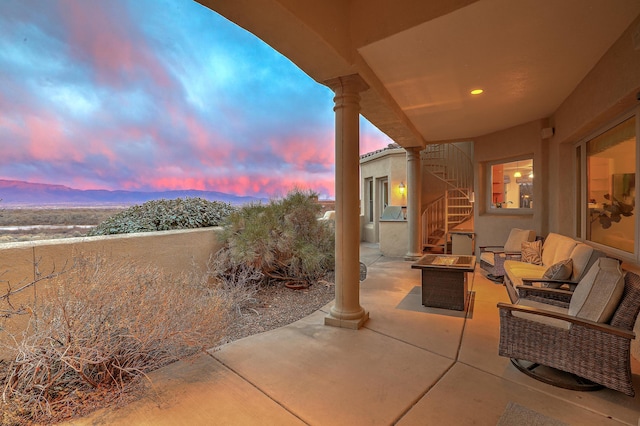 4110 Waterwillow Pl NW, Albuquerque, NM 87120 - patio terrace at dusk with an outdoor living space with a fire pit, a patio area, and stairway