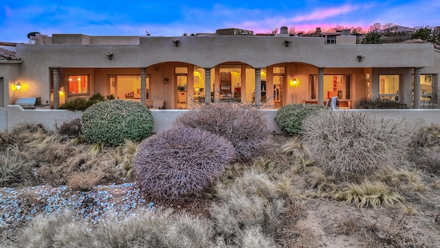 4110 Waterwillow Pl NW, Albuquerque, NM 87120 - back of property at dusk with stucco siding