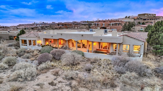 4110 Waterwillow Pl NW, Albuquerque, NM 87120 - back of house featuring stucco siding, a chimney, and a residential view