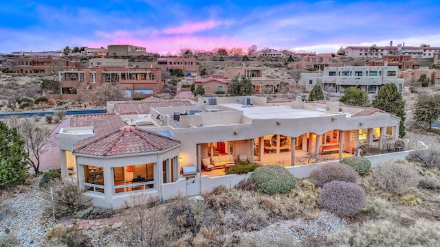 4110 Waterwillow Pl NW, Albuquerque, NM 87120 - rear view of house with stucco siding, an outdoor living space, and a residential view