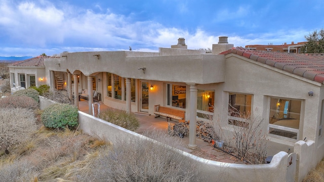 4110 Waterwillow Pl NW, Albuquerque, NM 87120 - back of property featuring stucco siding, a chimney, and a tiled roof