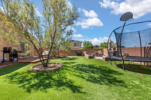 1227 Desert Paintbrush Loop, Rio Rancho, NM 87144 - view of yard featuring a trampoline and a wooden deck