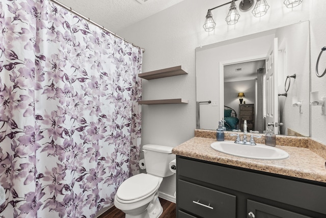 1227 Desert Paintbrush Loop, Rio Rancho, NM 87144 - full bathroom featuring toilet, vanity, wood finished floors, a shower with shower curtain, and a textured ceiling