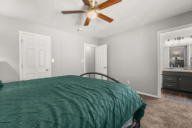 1227 Desert Paintbrush Loop, Rio Rancho, NM 87144 - bedroom with dark carpet, baseboards, a textured ceiling, ensuite bathroom, and ceiling fan