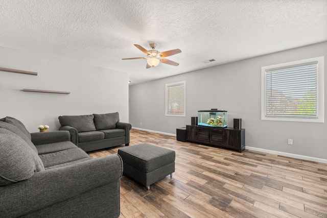 1227 Desert Paintbrush Loop, Rio Rancho, NM 87144 - living room with wood finished floors, a ceiling fan, baseboards, and a textured ceiling