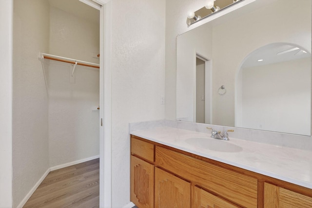 2517 Georgene Dr NE, Albuquerque, NM 87112 - bathroom with vanity, wood finished floors, and a walk in closet