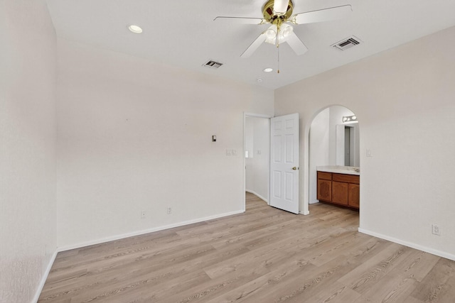 2517 Georgene Dr NE, Albuquerque, NM 87112 - empty room with a ceiling fan, light wood-type flooring, arched walkways, and recessed lighting