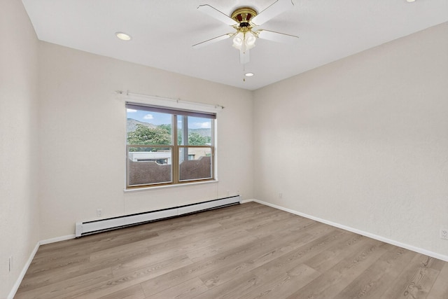2517 Georgene Dr NE, Albuquerque, NM 87112 - spare room featuring baseboard heating, wood finished floors, a ceiling fan, and recessed lighting