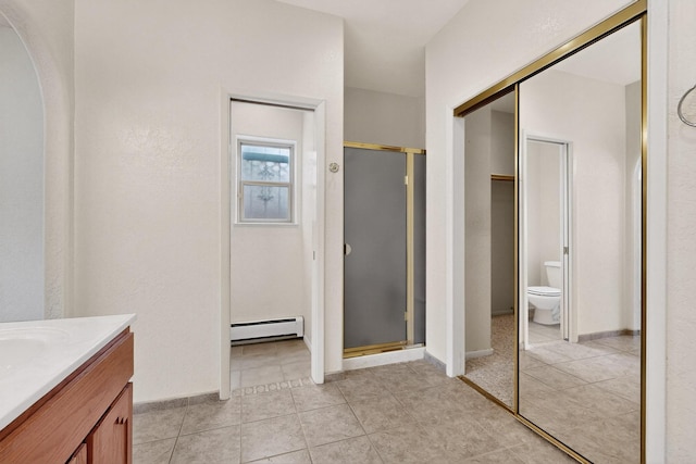 2517 Georgene Dr NE, Albuquerque, NM 87112 - full bathroom with baseboard heating, vanity, a shower stall, and tile patterned flooring