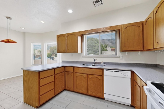 2517 Georgene Dr NE, Albuquerque, NM 87112 - kitchen with white appliances, a peninsula, decorative light fixtures, recessed lighting, and brown cabinets