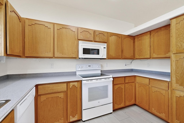 2517 Georgene Dr NE, Albuquerque, NM 87112 - kitchen featuring white appliances, light countertops, light tile patterned floors, and brown cabinets