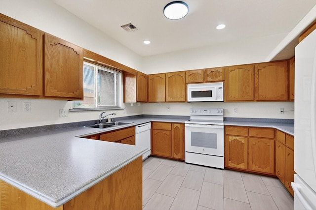 2517 Georgene Dr NE, Albuquerque, NM 87112 - kitchen featuring white appliances, a peninsula, brown cabinetry, and recessed lighting