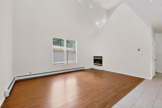 2517 Georgene Dr NE, Albuquerque, NM 87112 - unfurnished living room with ceiling fan, a baseboard heating unit, recessed lighting, and light wood-style floors
