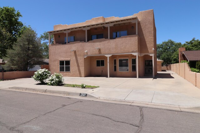 2517 Georgene Dr NE, Albuquerque, NM 87112 - unfurnished living room with a towering ceiling, light wood-style floors, baseboard heating, and a glass covered fireplace