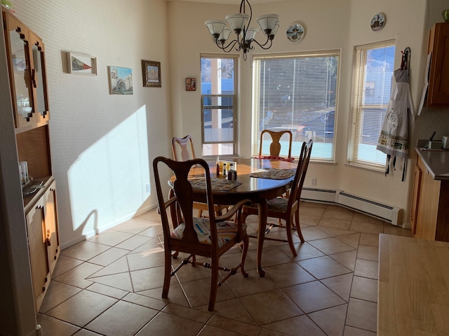 2517 Georgene Dr NE, Albuquerque, NM 87112 - dining room featuring a baseboard radiator, a chandelier, and tile patterned flooring