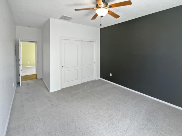1713 Caramesa Dr SE, Rio Rancho, NM 87124 - unfurnished bedroom with carpet flooring, a closet, baseboards, and ceiling fan