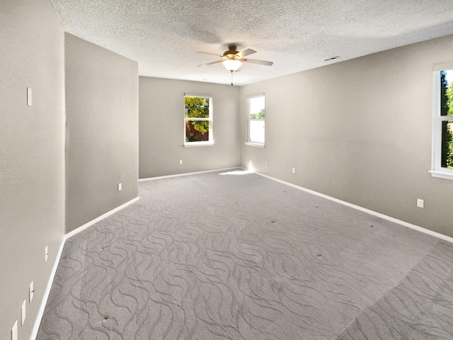 1713 Caramesa Dr SE, Rio Rancho, NM 87124 - empty room with ceiling fan, baseboards, carpet flooring, and a textured ceiling