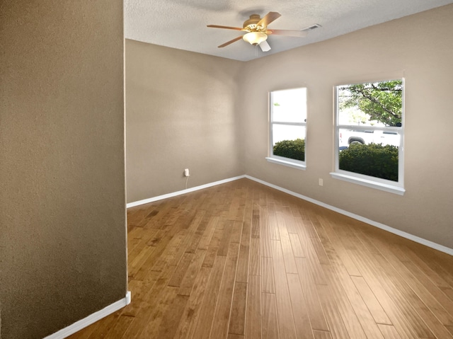 1713 Caramesa Dr SE, Rio Rancho, NM 87124 - unfurnished room with a ceiling fan, wood finished floors, and baseboards