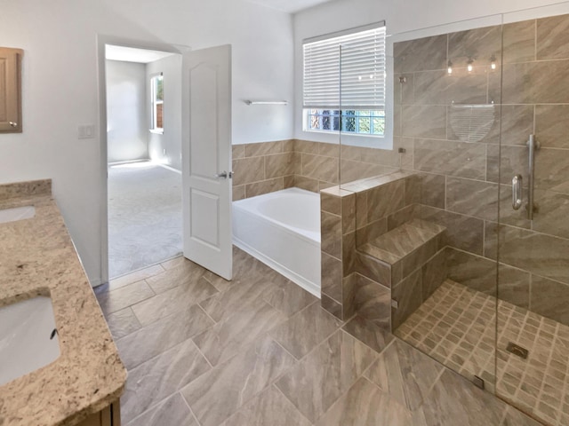 1713 Caramesa Dr SE, Rio Rancho, NM 87124 - bathroom featuring double vanity, a bath, a stall shower, and plenty of natural light