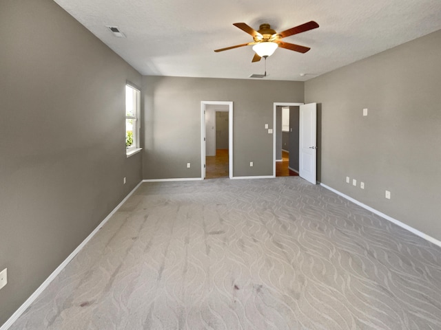 1713 Caramesa Dr SE, Rio Rancho, NM 87124 - unfurnished bedroom with baseboards, light colored carpet, and a ceiling fan