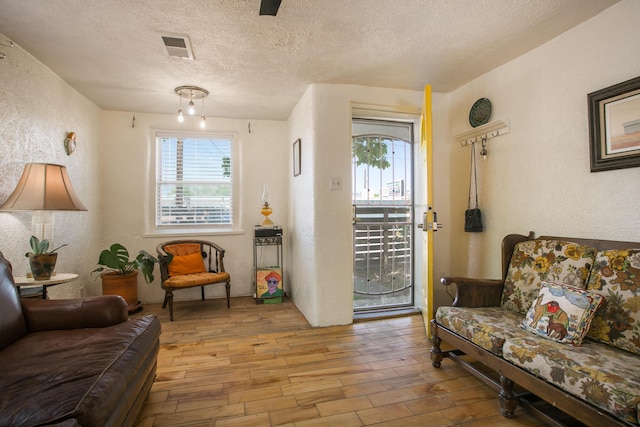 1508 Barelas Rd SW, Albuquerque, NM 87102 - living room featuring wood finished floors, a textured wall, and a textured ceiling