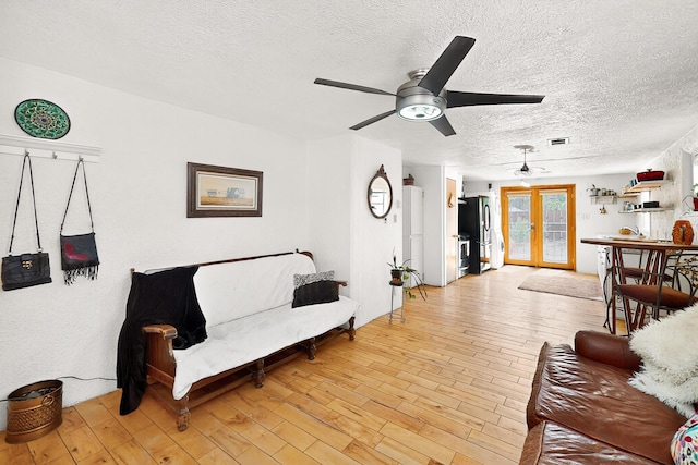 1508 Barelas Rd SW, Albuquerque, NM 87102 - living room with a textured ceiling, a ceiling fan, and light wood-style flooring
