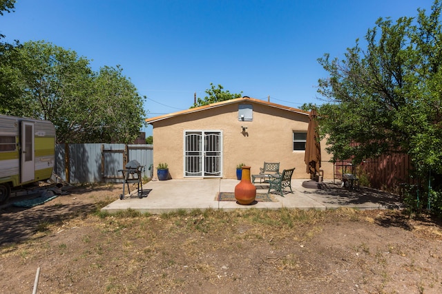 1508 Barelas Rd SW, Albuquerque, NM 87102 - back of house with stucco siding, a fenced backyard, and a patio area