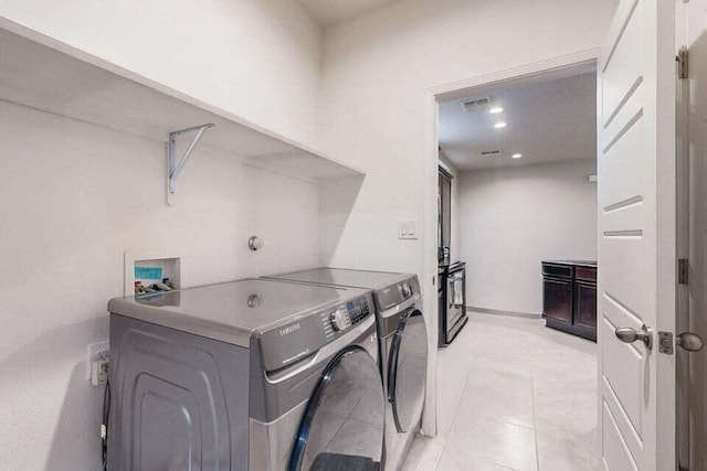1472 Tierra Verde Loop, Los Lunas, NM 87031 - laundry area featuring separate washer and dryer, light tile patterned floors, and recessed lighting