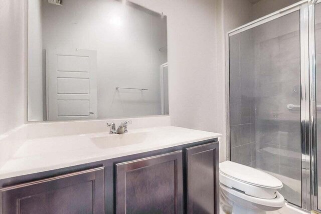 1472 Tierra Verde Loop, Los Lunas, NM 87031 - full bathroom with vanity, toilet, and a stall shower