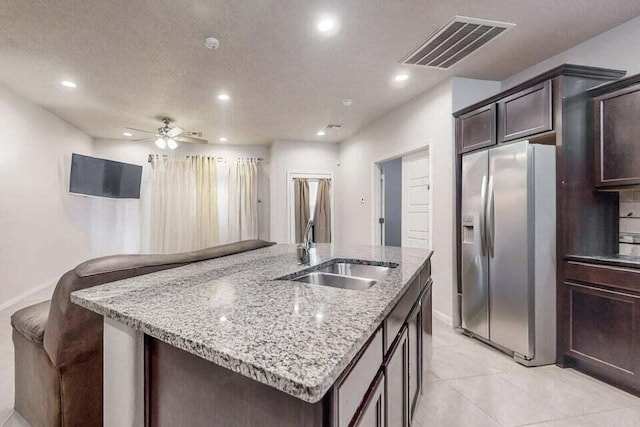 1472 Tierra Verde Loop, Los Lunas, NM 87031 - kitchen featuring stainless steel refrigerator with ice dispenser, a sink, baseboards, a center island with sink, and recessed lighting